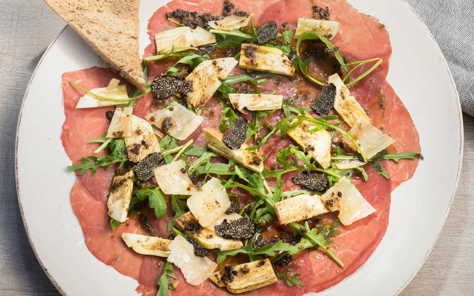 Rindercarpaccio mit Artischocken und Schwarzer Trüffel